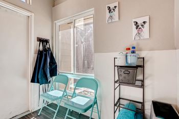 A room with a chair, a table, and a window.